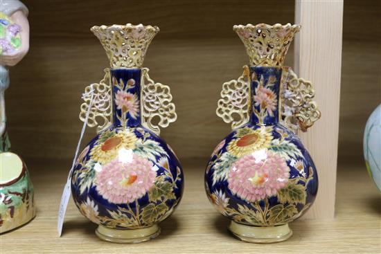 A pair of Zsolnay Pecs reticulated vases, floral-decorated on a blue ground and heightened in gilt height 20cm (a.f.)